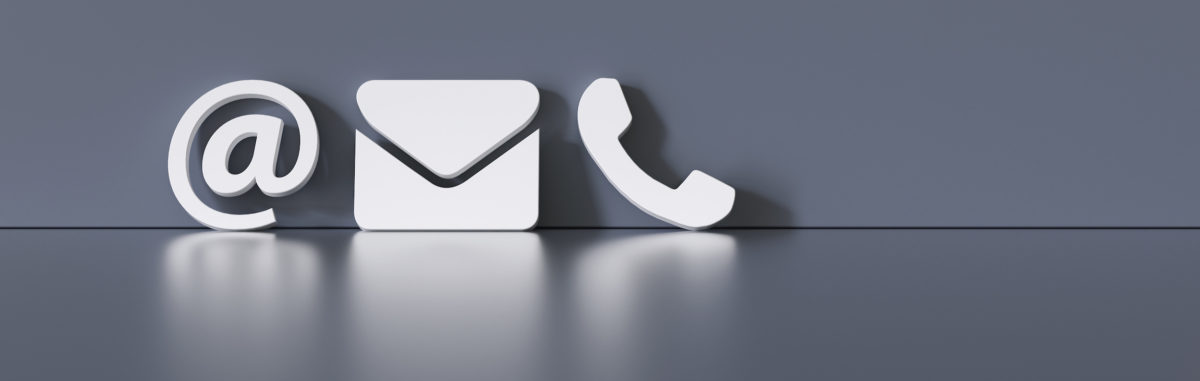 Contact Methods. Close-up Of A Phone, Email and Post Icons Leaning On gra Wall